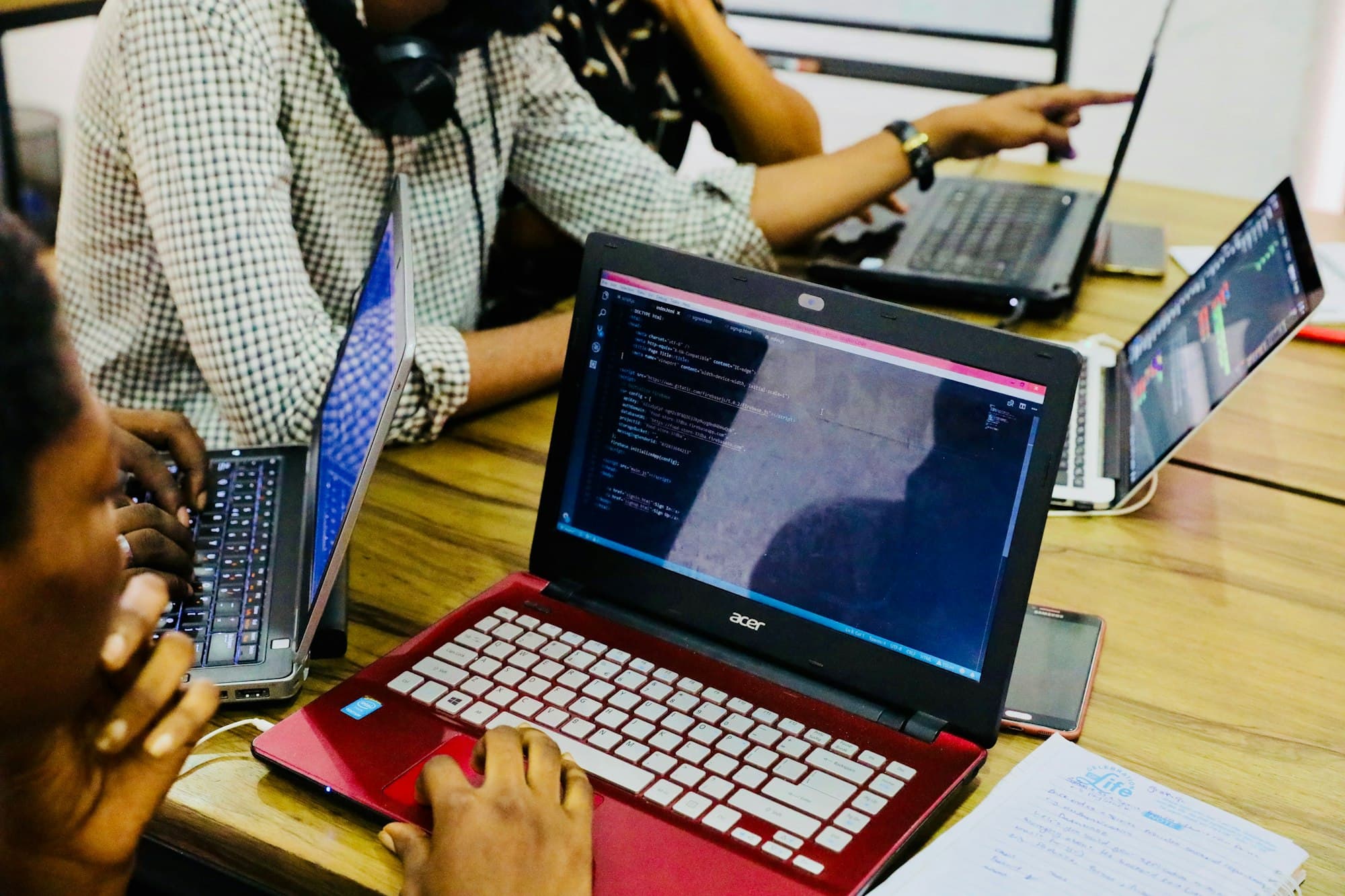 Software engineers collaborating at their laptops