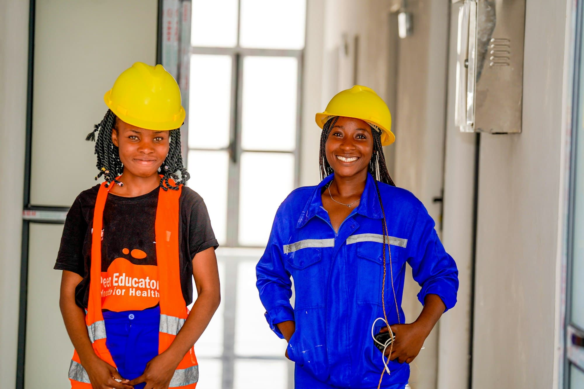 Two engineers in hard hats and work overalls