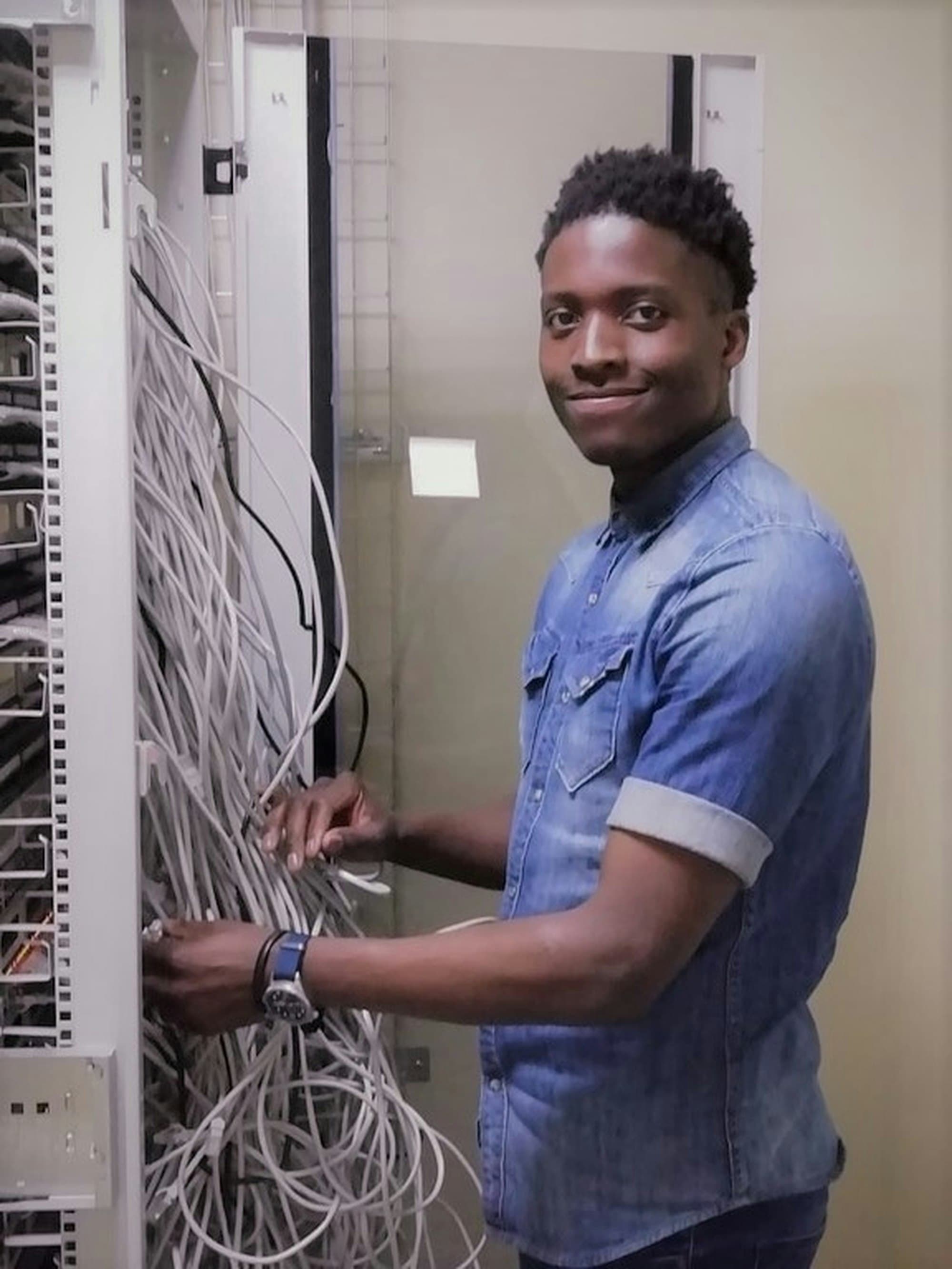 Technician organising network cabling in a server cabinet