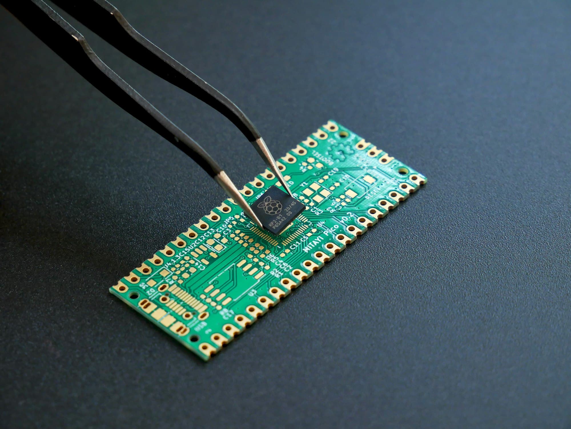 Engineer placing a component on a circuit board with tweezers